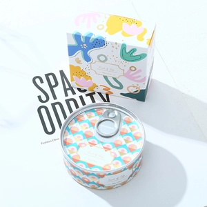 Detailed view of 80g tin candle with abstract pattern and matching gift box packaging