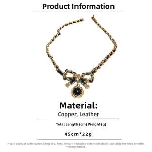 Detailed view of dark style faux leather chain necklace with bow and flower pendants