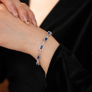 Close-up of vintage bracelet with oval blue gemstones and marquise silver settings