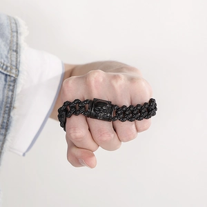 Close-up of a black gothic skull Cuban chain bracelet in a punk style for men