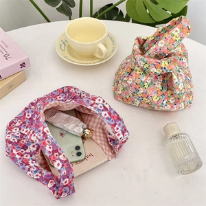 Detailed interior of corduroy floral wristlet showing phone storage and plaid lining
