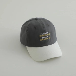 Detail of LUCKY WHATEVER embroidery on a two-tone cotton twill kids baseball cap