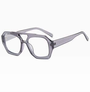 Detail view of retro geometric double-bridge frames in transparent grey plastic finish