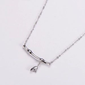 Silver stainless steel bamboo joint necklace with leaf pendant on white background