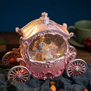 Pink princess pumpkin carriage snow globe music box with internal glowing lights