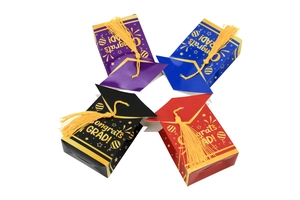 Detail of colorful graduation cap gift boxes with tassels and Congrats Grad printing