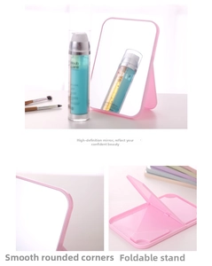 Detail of pink portable vanity mirror showing foldable stand and round edges