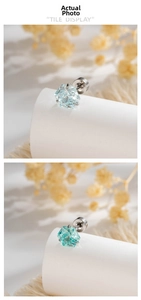 Detail of hexagonal cut crystal earrings in light blue and mint green with six-prong setting
