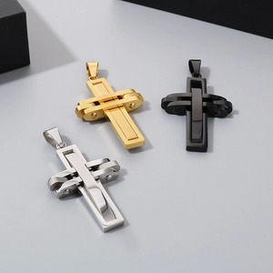 Detailed view of cross pendants in gold, black and silver stainless steel finishes
