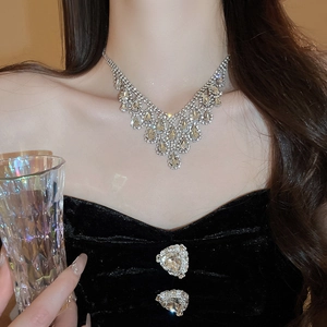 Close-up of elegant V-shaped rhinestone tassel necklace on model for formal attire