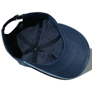 Detailed interior of navy washed cotton baseball cap with reinforcement tape and metal buckle