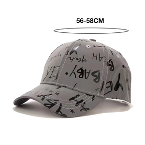 Macro shot of grey baseball cap with black graffiti prints and 56-58cm size details