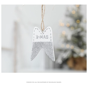 Close-up of white wooden Xmas star ornament with silver glitter and X-MAS lettering