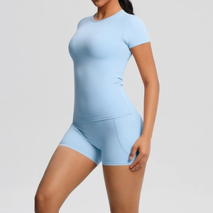 Side view of light blue compression yoga set featuring short sleeve top and high waist shorts