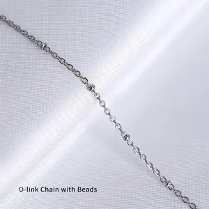 Silver O-chain necklace with beads on silk background in a professional 45-degree angle view