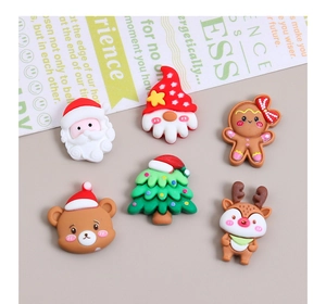 Flat lay of Christmas DIY resin charms including Santa, gingerbread man, and tree