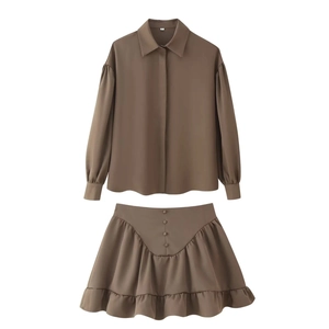 Flat lay of brown long-sleeve shirt and ruffle skirt set with lapel button-down detail