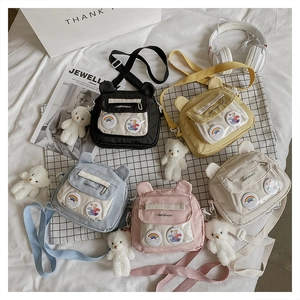 Flat lay of colorful canvas crossbody bags with cute bear ears and transparent pockets