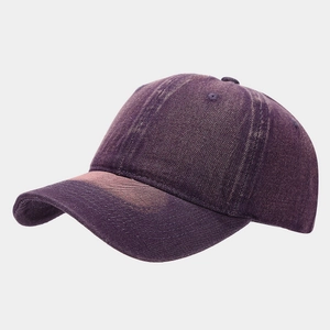 Macro detail of purple washed denim baseball cap showing retro faded seams and eyelets