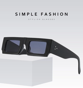 Detail of black rectangular thick frame sunglasses with three-point metal studs on wide temples