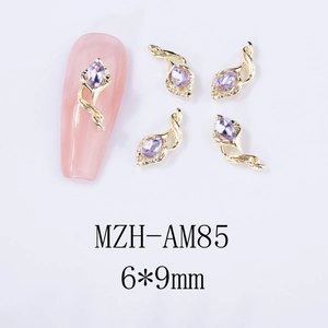 Detailed macro view of 6x9mm gold alloy horse-hoof flower nail charms with purple rhinestones