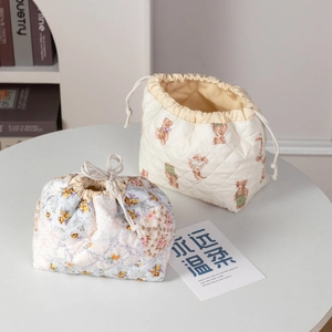 Quilted cotton drawstring cosmetic bags in floral and teddy bear patterns for travel