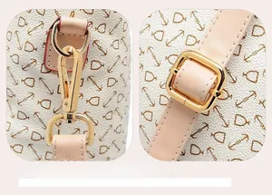Detail of adjustable leather shoulder strap with gold metal hooks and nautical anchor prints