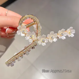 Elegant gold flower hair claw clip with rhinestones and white petals, 11cm length