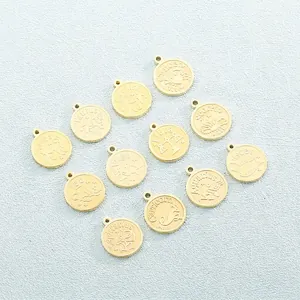 Detail view of 12 gold stainless steel zodiac pendants with engraved signs and names