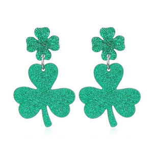 Green glitter shamrock dangle earrings with two interconnected clover shapes on white background