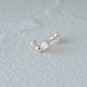 Detailed view of silver labret cartilage stud with heart and butterfly stacking stones