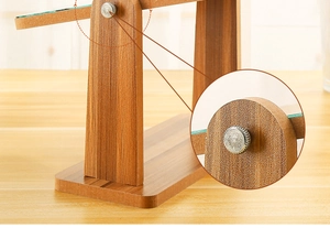 Close-up of the adjustable silver metal knob on the wooden desktop vanity mirror stand