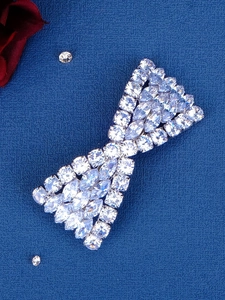Close-up of sparkling silver crystal bow hair clip with brilliant zircon stones detail