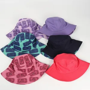 Detail shot of assorted cotton bucket hats with NECY STUDIO print and stitched brim