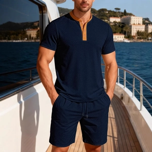 Men's navy color-block short sleeve shirt and shorts set on a luxury yacht