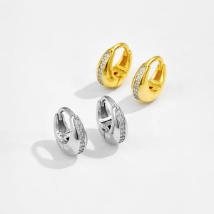 Detail view of gold and silver S925 sterling silver hoop earrings with zircon stones