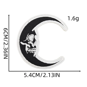 Detail showing dimensions of moon skull embroidered patch 6cm by 5.4cm in black and white