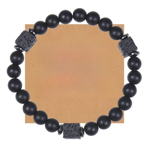 Detail of matte black stone beaded bracelet with lava rock accents on a gift message card
