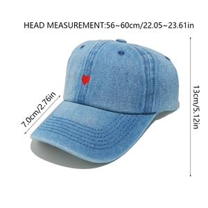 Detail view of denim baseball cap showing heart embroidery and size dimensions