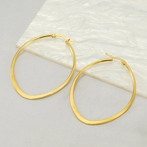 Minimalist 18k gold plated stainless steel oval hoop earrings for women on marble