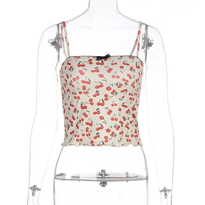 Detail of floral crop top with red cherry print, black lace trim and bow accent