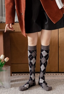Detail view of knitted cotton Argyle knee-high socks with vintage British college style