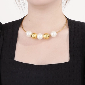 Chic gold neck cuff with alternating pearl and metal beads worn by a female model