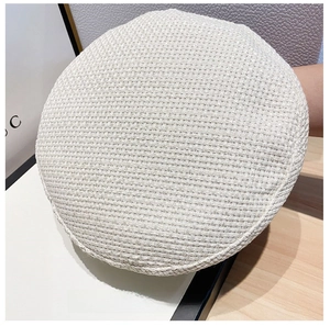 Close-up of white waffle texture knit beret cap showing detailed woven fabric pattern