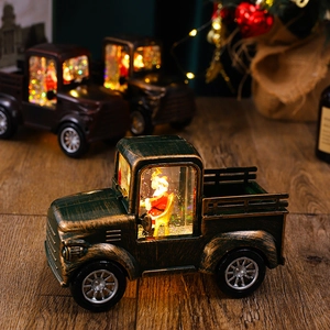 Close-up of Santa Claus driving a green vintage truck water lantern with festive warm lights