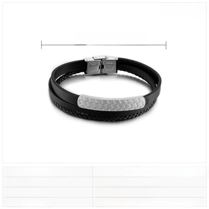 Macro detail of men's woven leather bracelet featuring hexagonal steel pattern