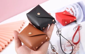 Detailed view of mini PU leather coin purses with metallic buttons in various colors