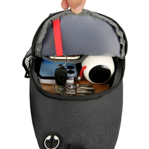 Spacious main compartment of grey crossbody bag showing smartphone and water bottle