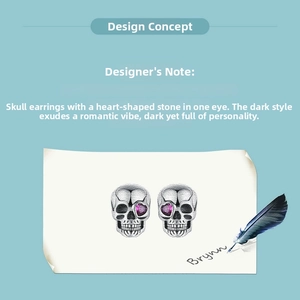 Macro shot of S925 silver skull earrings featuring a pink heart-shaped crystal eye