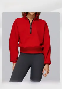 Detailed view of red half-zip fleece sweatshirt with ribbed cuffs and high collar neck